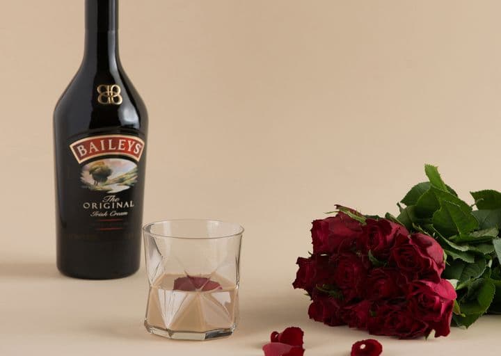 Baileys Original lifestyle image with glass and roses