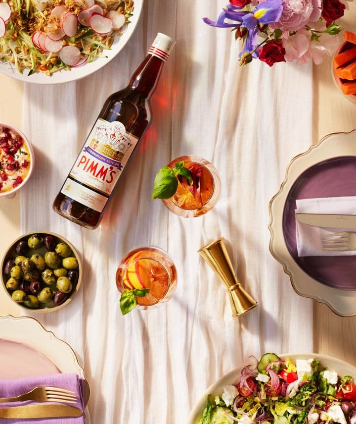 Pimm's Coronation bottle on table surrounded by food 