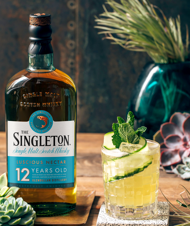 La imagen muestra una botella del whisky The Singleton 12 años junto a un vaso relleno con el cóctel Maid in Scotland.